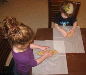 Reader Kate's kids shaping challah dough