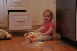 toddler getting into a drawer in the kitchen