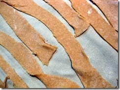 homemade noodles drying on a cloth