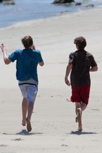 Healthy teens run on beach