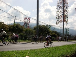 Bike riders with Christmas decorations in background