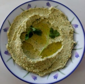 Chumus with coriander and parsley in bowl