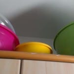 large mixing bowls on top of the cabinet